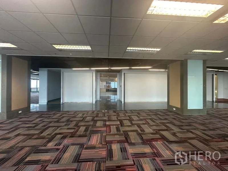 Office Space for rent in Khlong Toei, Bangkok - Open workspace showing columns, patterned carpet and access to the lobby.