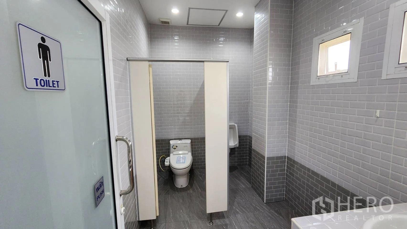 Factory for sale in Bang Bo, Samut Prakan - Side driveway along boundary wall with landscaping trees.