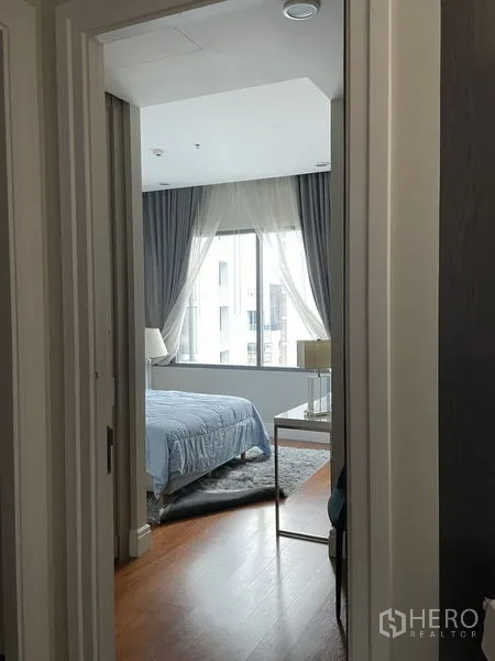 คอนโด ให้เช่าในKhlong Toei, Bangkok - ห้องนอนสว่างมีหน้าต่างบานกว้าง ผ้าม่านทึบกับผ้าโปร่ง และเตียงผ้าปูสีฟ้า