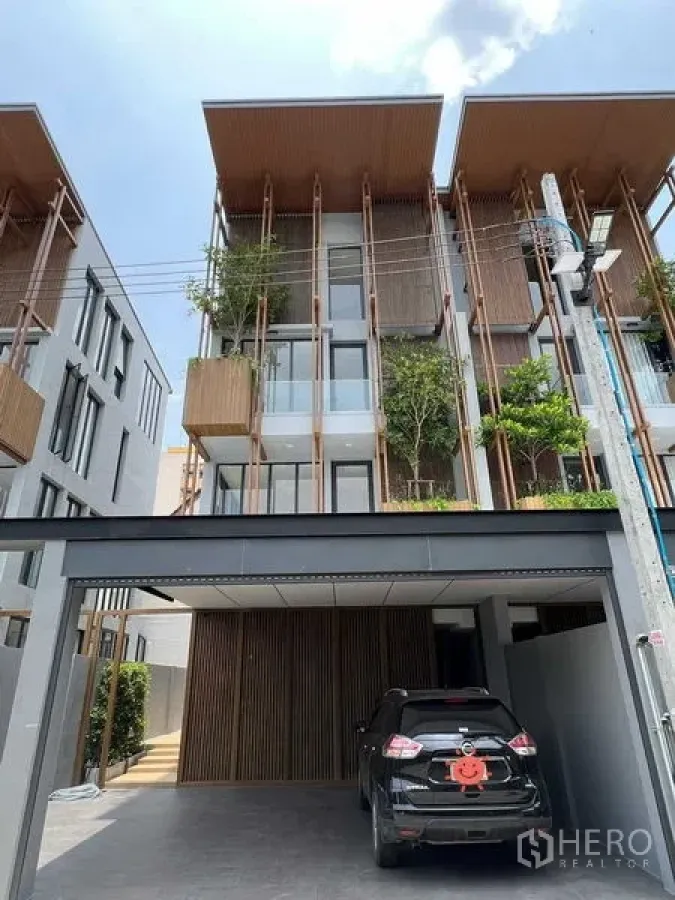Home Office for sale in Wang Thonglang, Bangkok - Front facade of a four-storey home office with covered carport and planter boxes.
