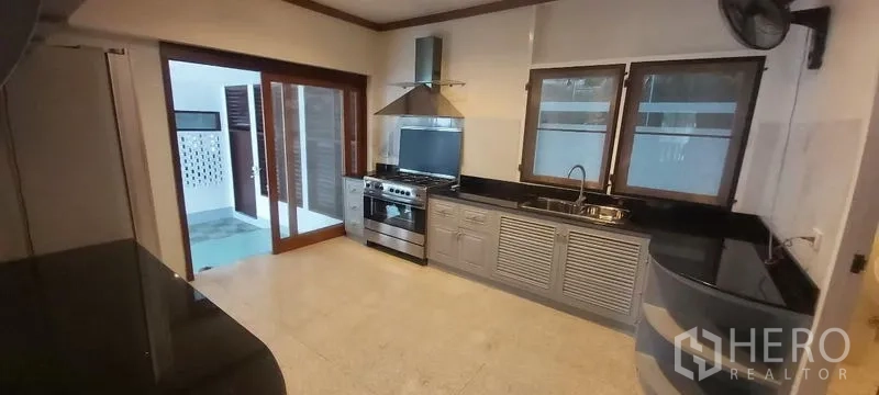 独立式住宅 出租在Pathum Wan, Bangkok - 配备燃气灶、抽油烟机和黑色花岗岩台面厨房