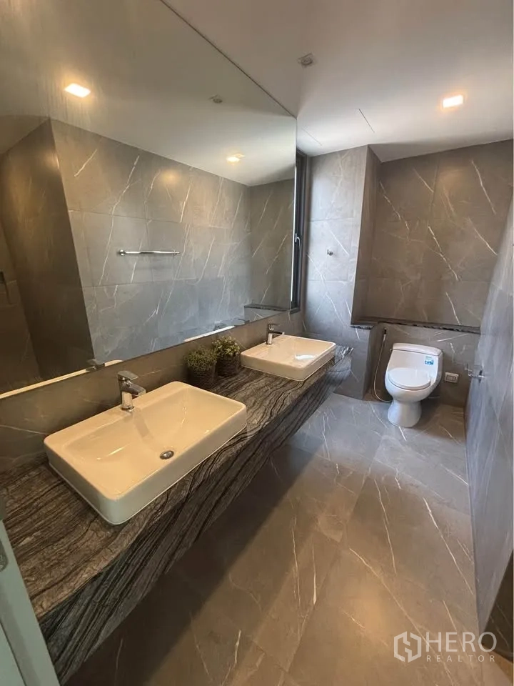 Home Office for rent or sale in Suan Luang, Bangkok - Bathroom featuring double sinks on a stone counter and a toilet.
