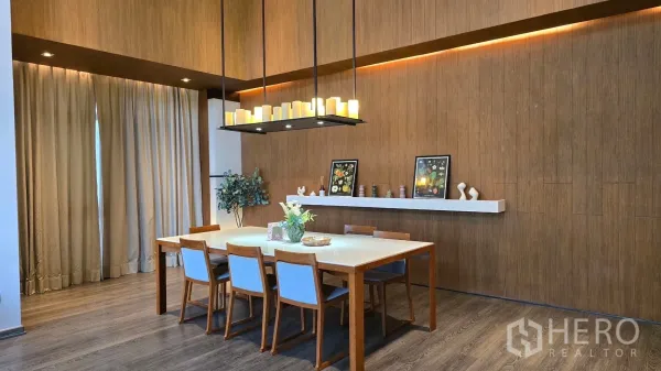 Condominium for rent - Dining area with six-seat wooden table, modern chandelier and feature shelf.
