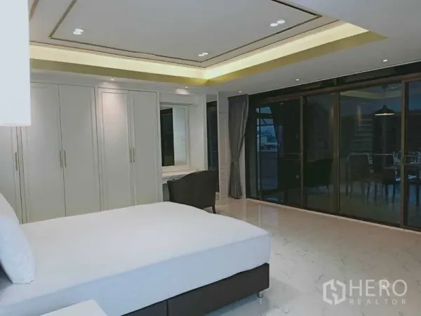 Condominium for  in Watthana, Bangkok - Bedroom with built-in closets and sliding glass doors to balcony.