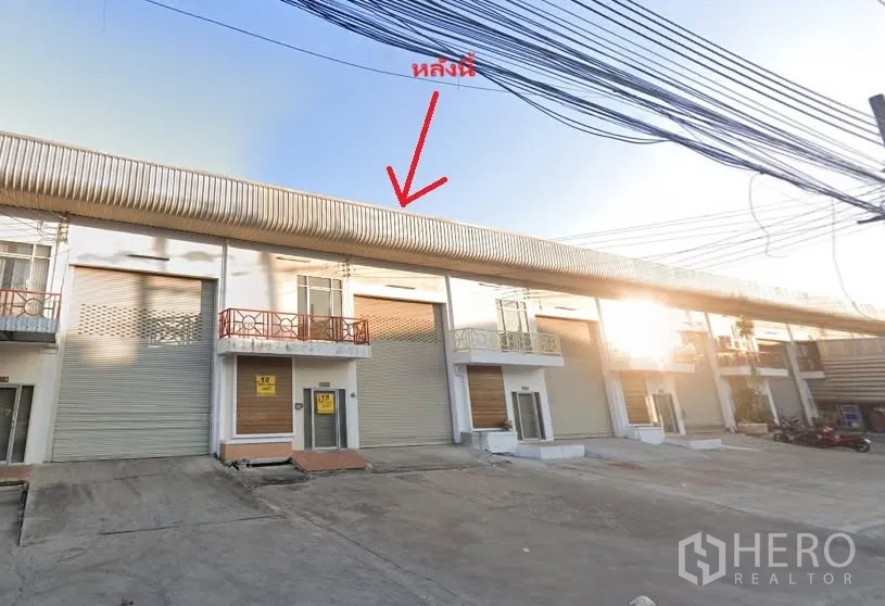 Factory for rent or sale in Bang Phae, Ratchaburi - Row of factory units with wide roller shutter doors and small balconies.