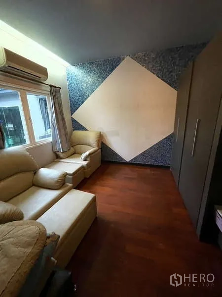 Detached House for sale in Suan Luang, Bangkok - Cozy sitting room with beige sofas, a geometric feature wall and wardrobe.