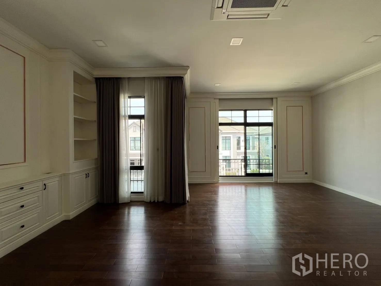 Detached House for rent or sale in Prawet, Bangkok - Large room opening to balcony with full-height windows and curtains.