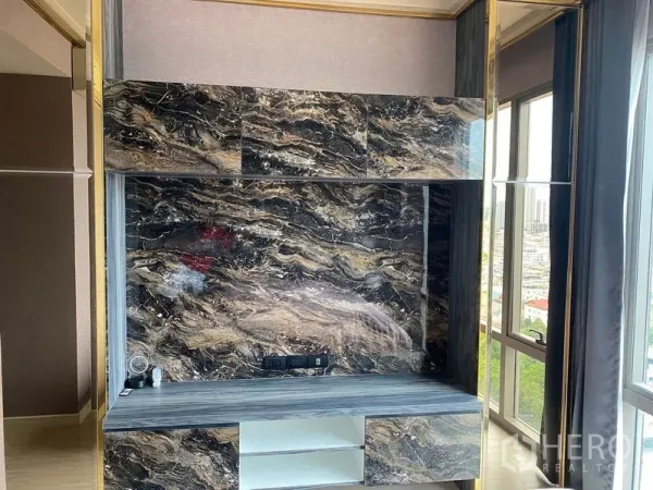 Condominium for sale in Bang Kho Laem, Bangkok - Close-up of luxury marble feature wall and storage cabinetry.