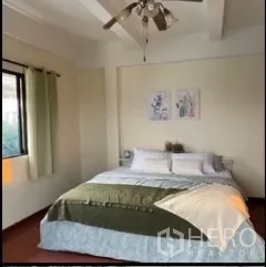 独立式住宅 出租在Phra Khanong, Bangkok - 采光充足的卧室，带吊扇与大窗，床铺整洁。