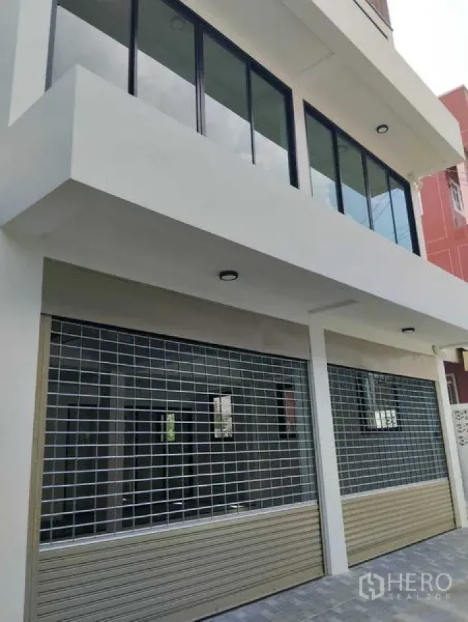 Home Office for sale - Street-level view featuring two roller shutters and large storefront windows suitable for parking or loading.