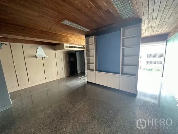 Office Space for rent - Bright office area with granite flooring, shelving wall and wide front glazing.