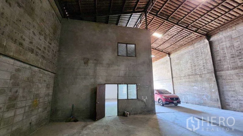 Warehouse for rent in Nong Khaem, Bangkok - Ground-level loading area with internal office block and wide vehicle entry.