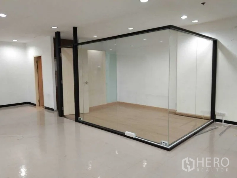 Office Space for rent in Watthana, Bangkok - Close-up of the glass-partitioned meeting room with wood flooring inside an open office.