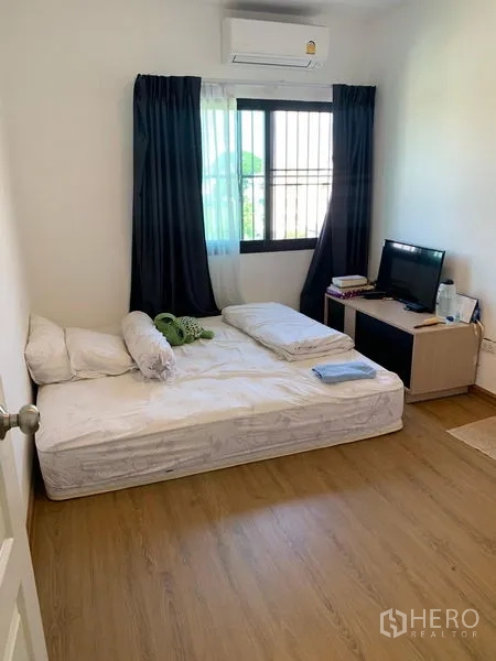 Office Space for sale in Saphan Sung, Bangkok - Cozy bedroom with window, blackout curtains, air conditioner and wood-look floor.