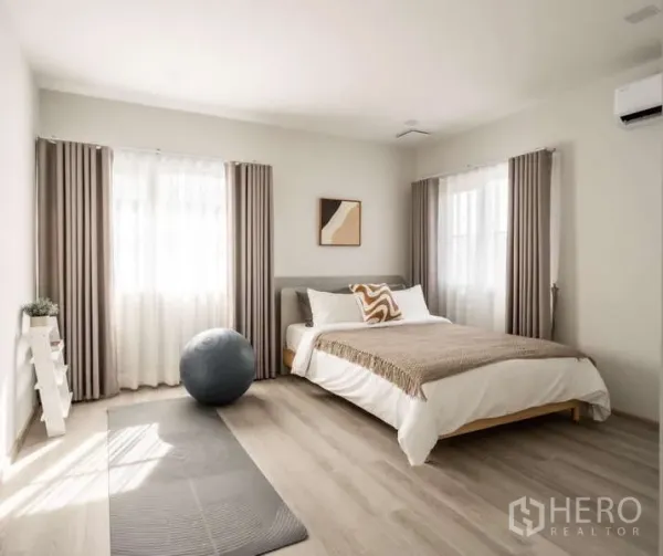 Detached House for rent or sale in Bang Phli, Samut Prakan - Bright bedroom with double bed, yoga mat and exercise ball, soft curtains and wood flooring.