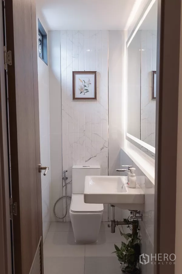 Home Office for sale in Don Mueang, Bangkok - Compact restroom with backlit mirror, wall tiles and square toilet.