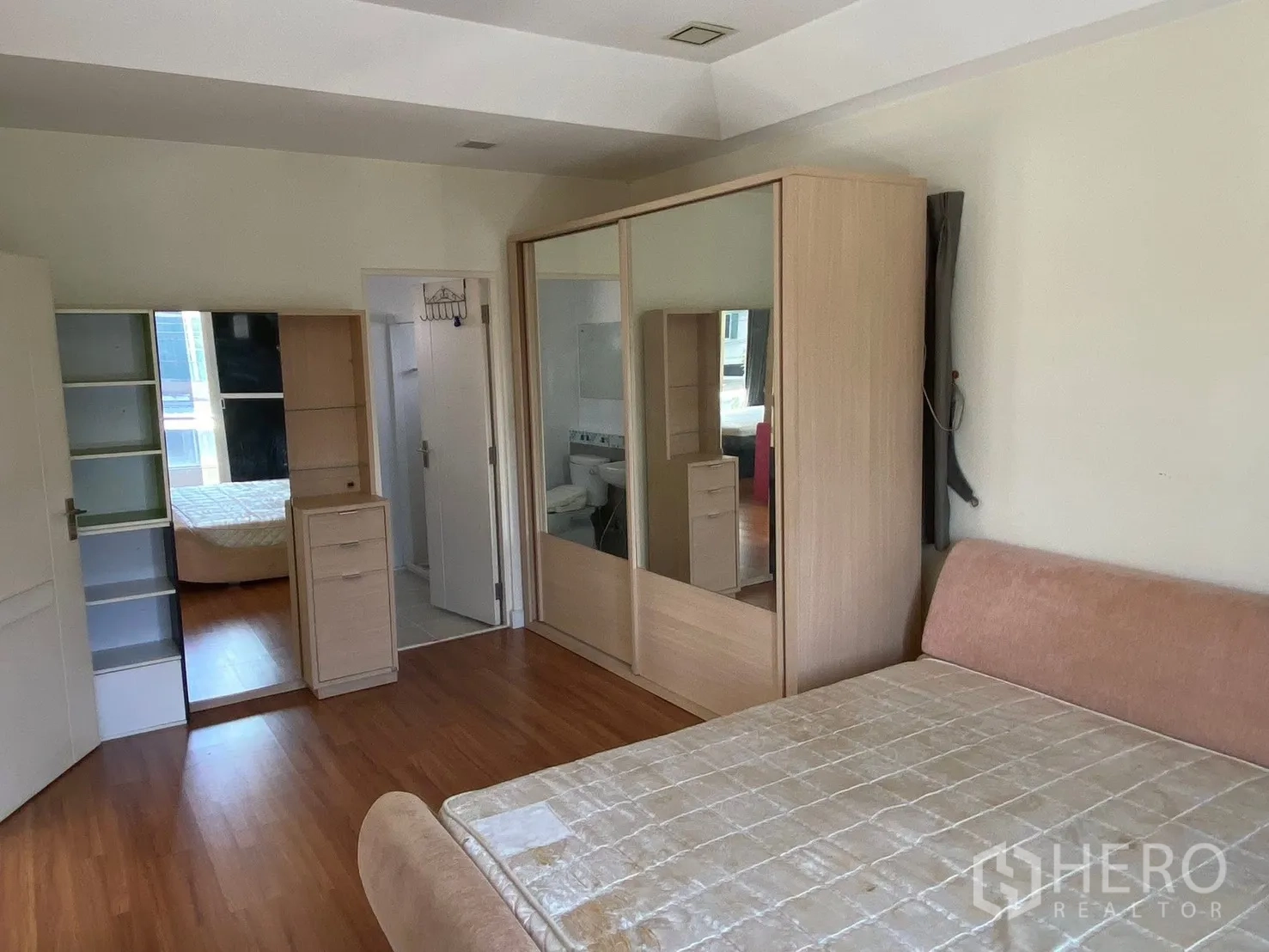 Detached House for rent in Prawet, Bangkok - Master bedroom view showing wardrobes and doorway to the bathroom.