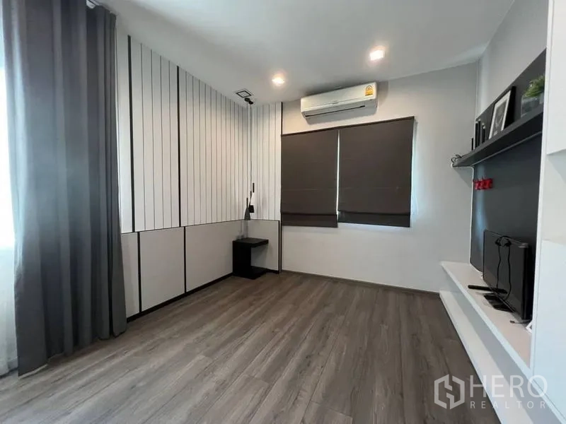 Detached House for rent or sale in Bang Phli, Samut Prakan - Bright bedroom or study with feature wall panels, shelves and air-conditioning.