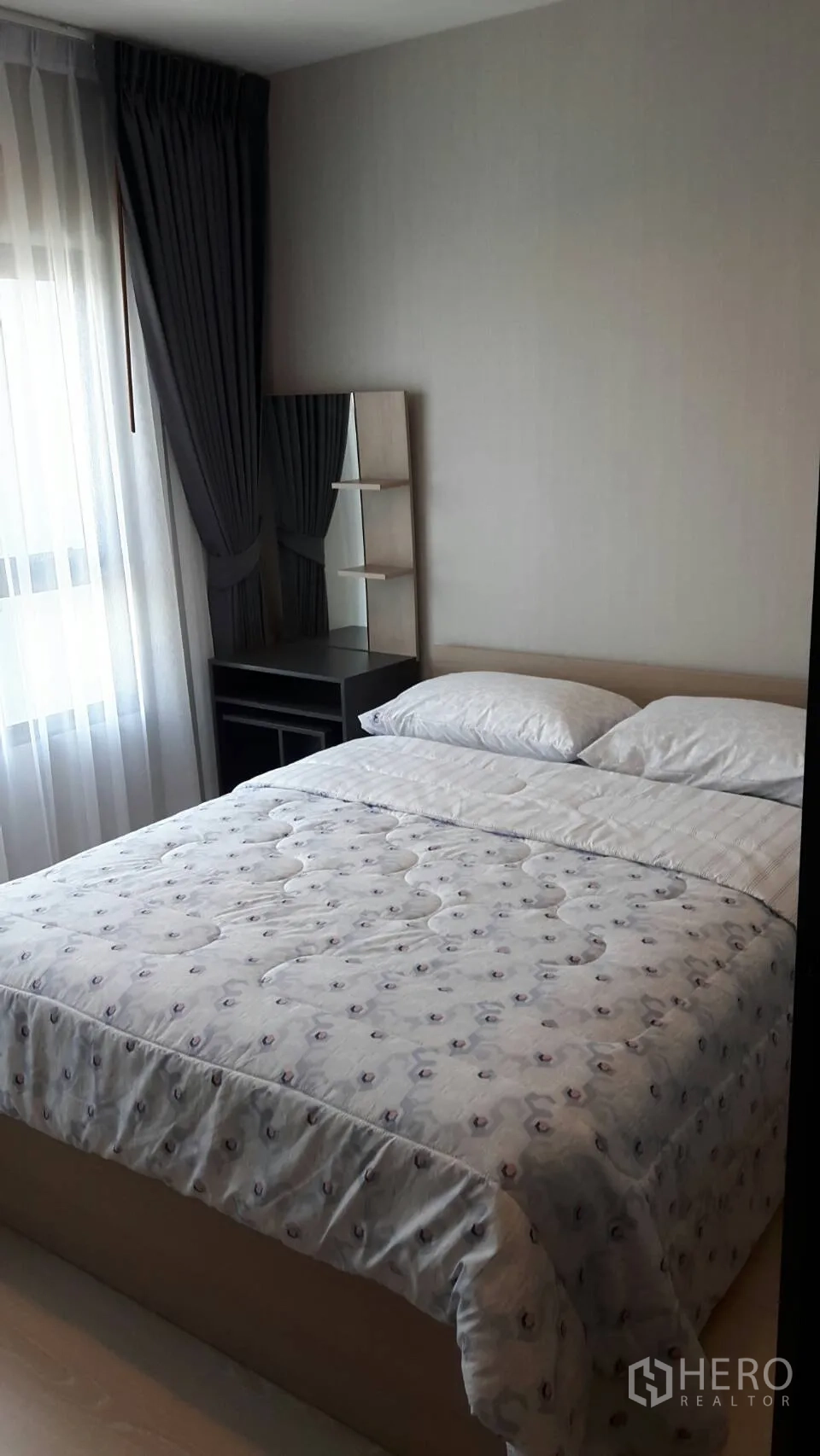 Condominium for rent in Samut Prakan - Cozy bedroom with double bed, sheer curtains, blackout drapes, and a dressing table by the window.