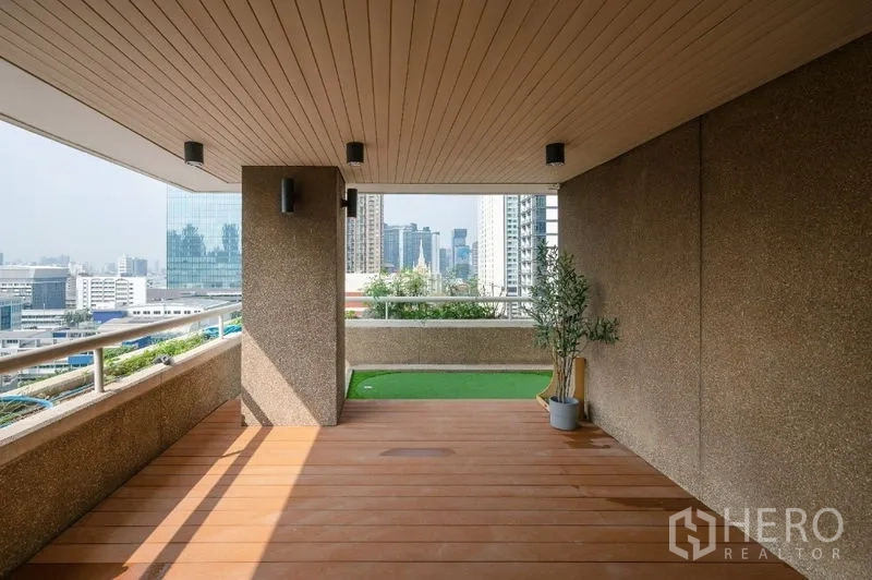Condominium for sale - Covered terrace with wood decking and panoramic city outlook.