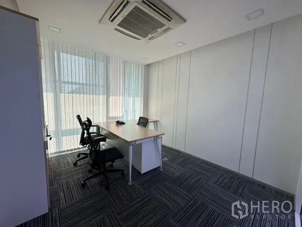 Office Space for rent - Bright manager’s office with two workstations, cassette air-conditioning and full-height windows with blinds.