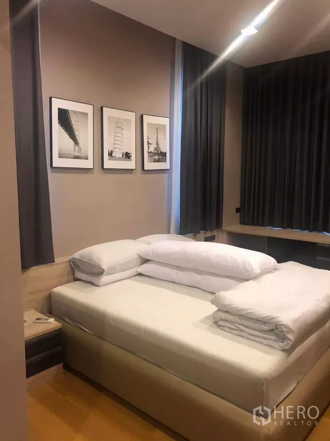 Detached House for rent in Bang Kapi, Bangkok - Bedroom with upholstered bed, artwork on the wall, blackout curtains and wood floor.