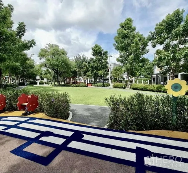 Townhouse for rent in Bang Phli, Samut Prakan - Green community park with playground equipment and walking paths.