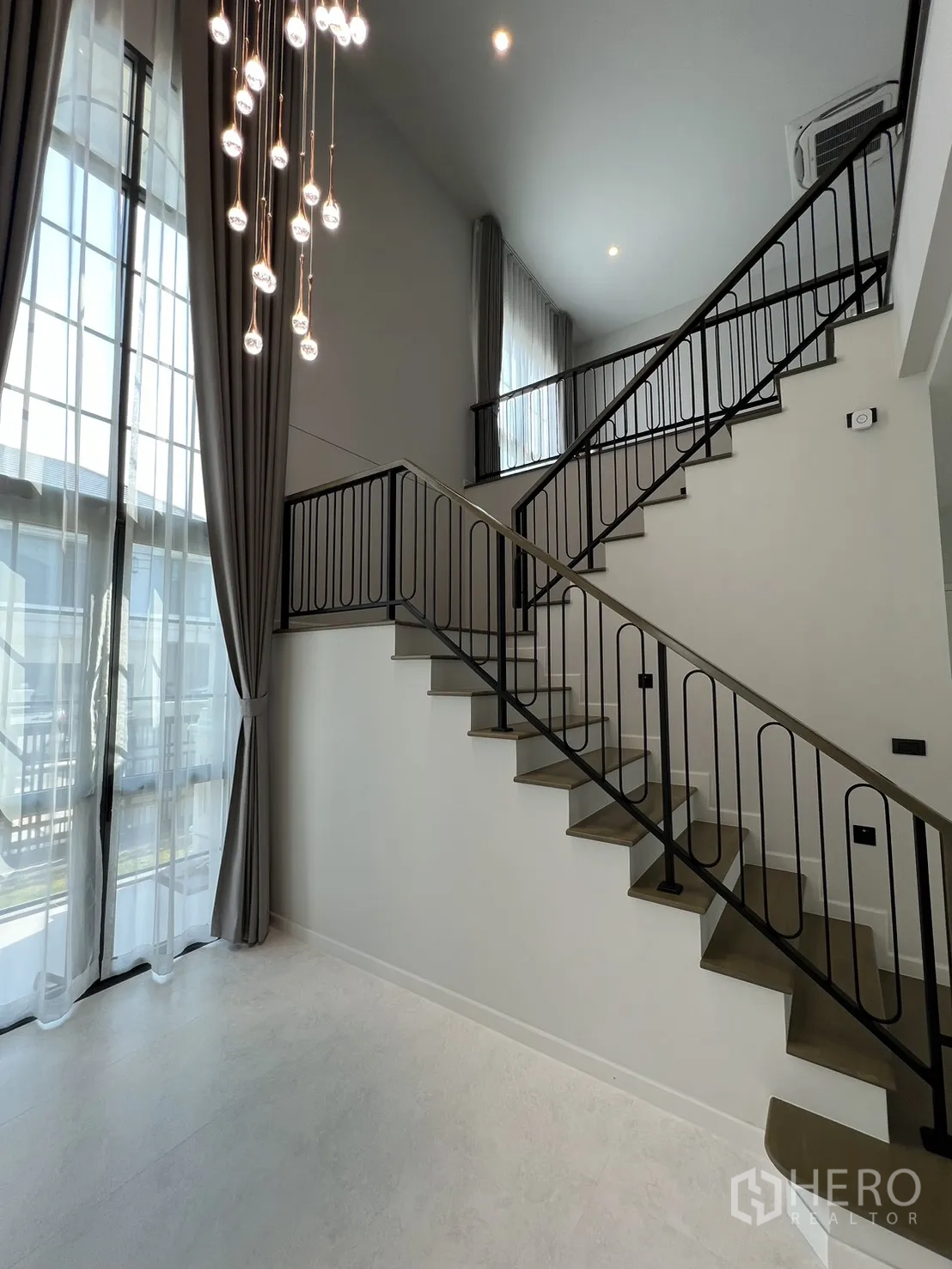 บ้านเดี่ยว for rent in Bang Phli, Samut Prakan - โถงทางเข้าฝ้าเพดานสูงพร้อมโคมไฟระย้าและบันไดราวเหล็ก