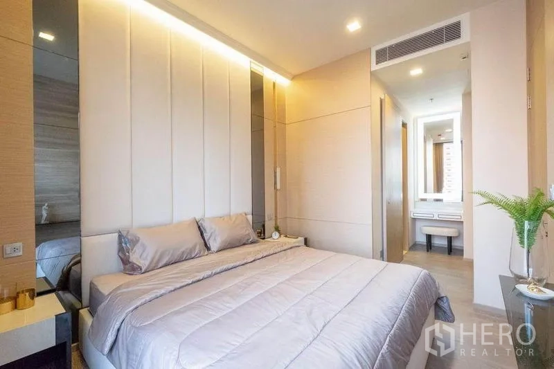 Condominium for rent in Watthana, Bangkok - Bedroom looking toward dressing area and corridor with ceiling air-conditioning vent.