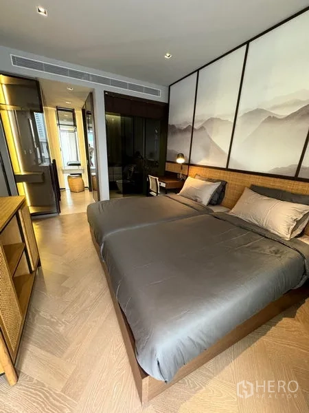 Condominium for rent in Watthana, Bangkok - Serene bedroom with king bed, mountain mural feature wall and ensuite access.