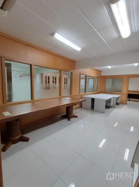 Warehouse for rent in Bang Phli, Samut Prakan - Office room with long worktables and glass partitions.