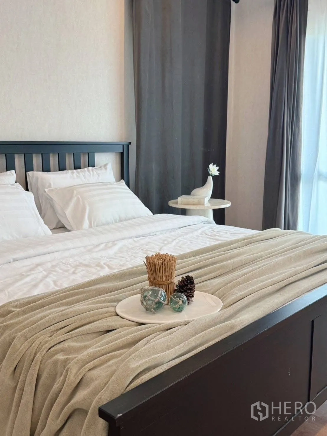 Detached House for rent or sale in Suan Luang, Bangkok - Bed with decorative tray and throw beside sheer drapes.
