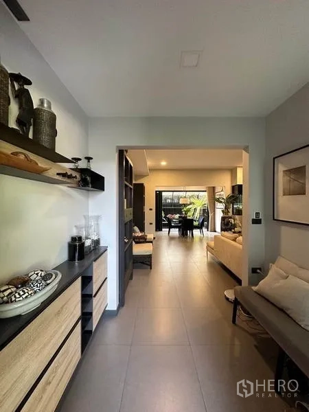 Townhouse for rent or sale in Bang Phli, Samut Prakan - View from corridor toward living and dining areas leading out to a garden terrace.