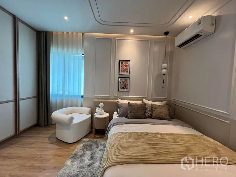 Detached House for sale in Saphan Sung, Bangkok - Cozy bedroom angle with air conditioning, sheer curtains and modern pendant light.