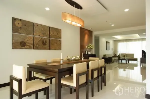 Condominium for rent in Watthana, Bangkok - Open-plan dining area with wooden table, pendant lighting and an adjoining living room with large windows.