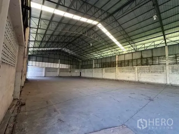 货栈 出租在Wang Noi, Phra Nakhon Si Ayutthaya - 空置仓库大厅，展示高挑屋顶、天窗采光带与通风砖墙。