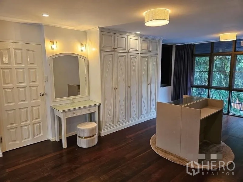 Detached House for rent - Dressing area with built-in wardrobes, vanity table, and warm ambient lighting.