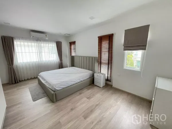 Detached House for rent or sale in Bang Phli, Samut Prakan - Spacious master bedroom with large windows, curtains and wood floors.