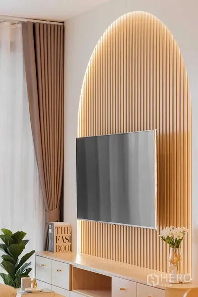 Condominium for rent in Watthana, Bangkok - Feature wall with arched slat paneling and mounted TV in a bright living room.
