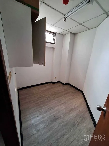 Office Space for rent in Watthana, Bangkok - Small storage or server room with a cabinet, drop ceiling and narrow window.
