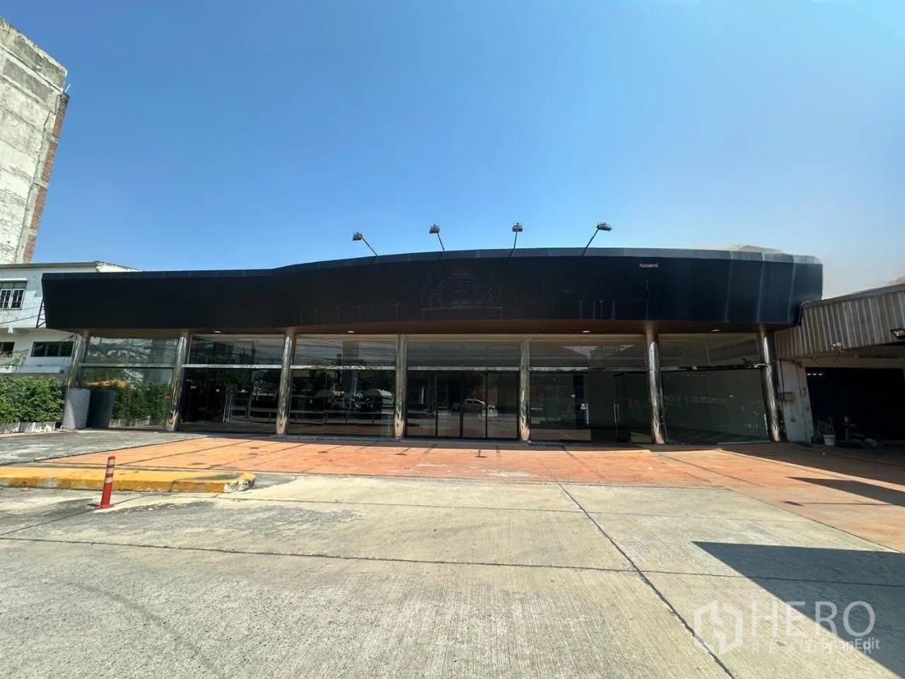 展厅 for rent in Suan Luang, Bangkok - 大面积落地玻璃立面与黑色雨棚的展示厅外观及前广场。