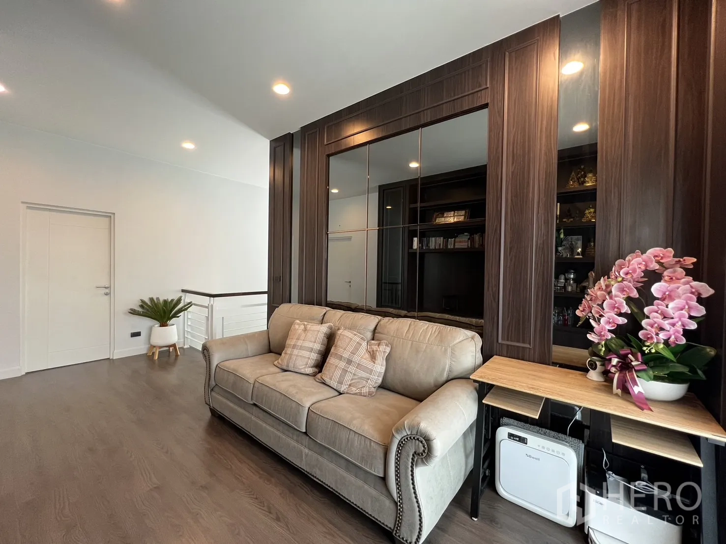 Detached House for rent or sale in Bang Kapi, Bangkok - Seating area on landing with sofa, mirror panel and potted plant.