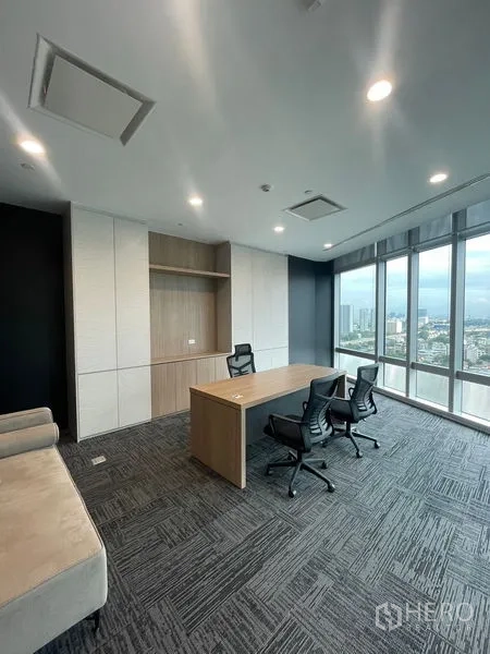 Office Space for rent in Dusit, Bangkok - Private executive office with desk, storage wall and floor-to-ceiling windows.