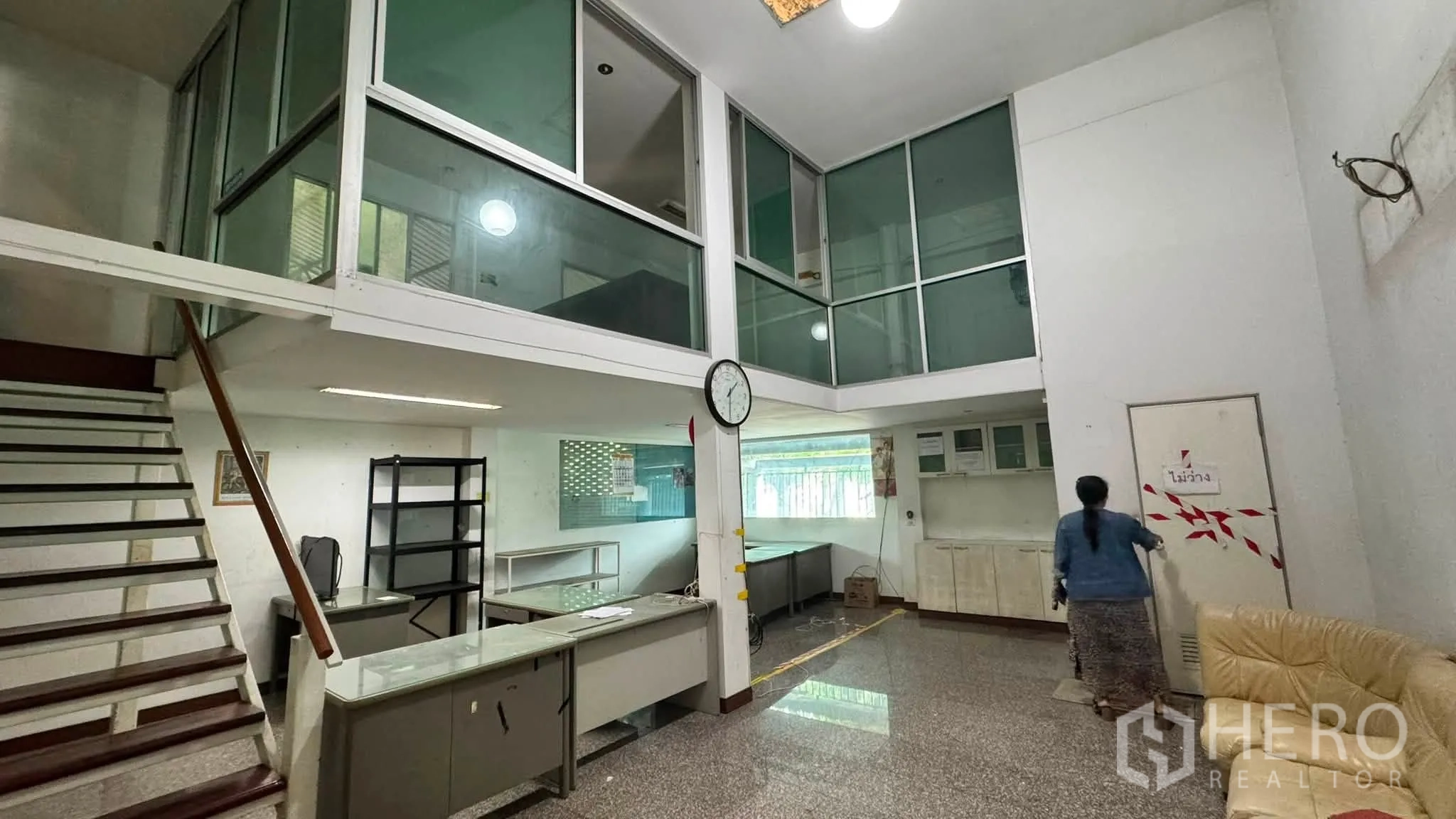 Warehouse for rent in Bang Khen, Bangkok - Ground-floor reception with glass-partitioned offices and stairs to the mezzanine.