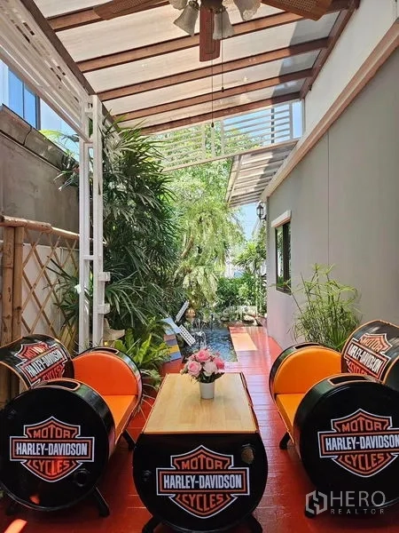 ทาวน์เฮาส์ ให้เช่า - เฉลียงกลางแจ้งมีหลังคา พร้อมชุดนั่งเล่นและต้นไม้ร่มรื่น