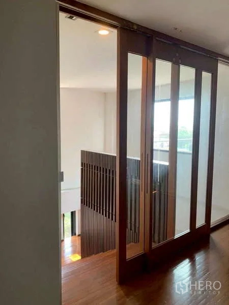 Home Office for rent or sale in Bang Phli, Samut Prakan - Sliding glass doors by the staircase bringing natural light into the corridor.