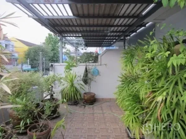 Home Office for rent or sale in Wang Thonglang, Bangkok - Covered side terrace with tiled floor and potted plants.