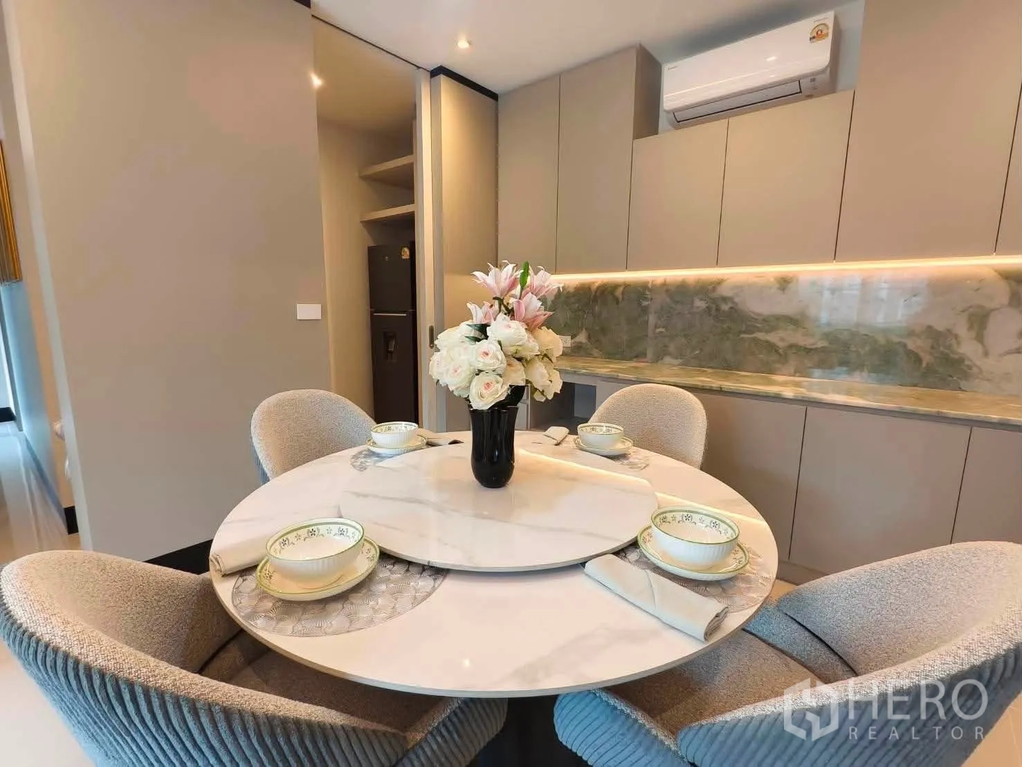 Detached House for rent in Bang Phli, Samut Prakan - Close view of dining area with ample storage cabinets and LED backsplash lighting.