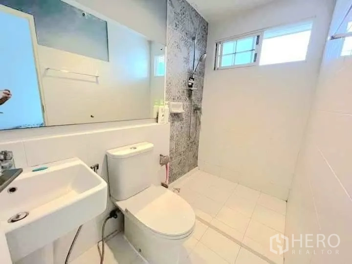 Townhouse for rent in Bang Phli, Samut Prakan - Bright bathroom with walk-in shower, toilet and large mirror.