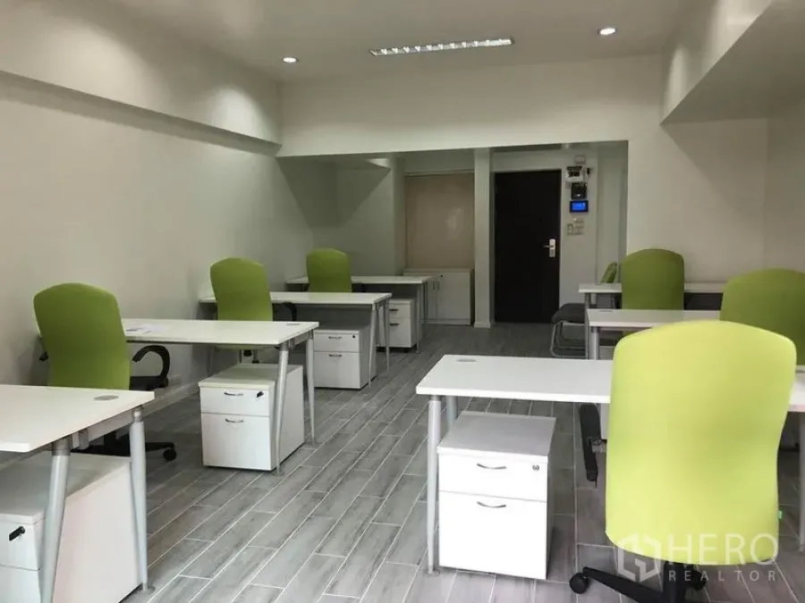 Office Space for rent in Khlong Toei, Bangkok - Bright furnished office featuring several desks, green task chairs, recessed ceiling lights and storage drawers.